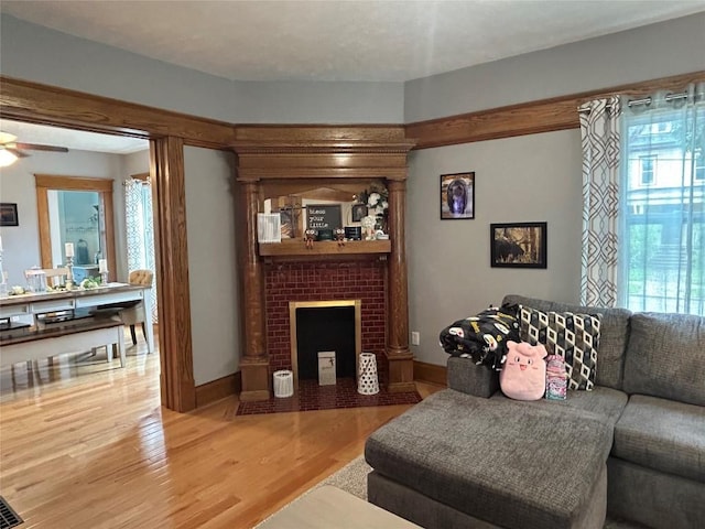 563 W 9th St, Erie, PA 16502 - living area with plenty of natural light, light wood-style floors, a fireplace, and a ceiling fan