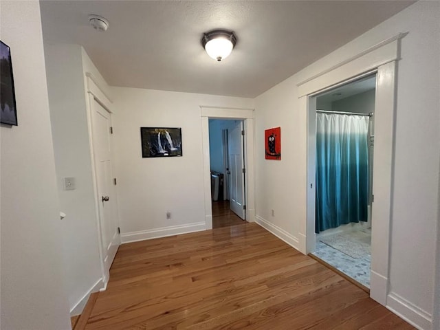 563 W 9th St, Erie, PA 16502 - hallway featuring wood finished floors and baseboards