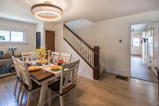 9 E Division St, North East, PA 16428 - dining room featuring stairs, light wood-style flooring, and plenty of natural light