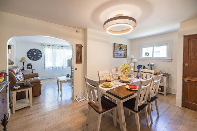 9 E Division St, North East, PA 16428 - dining area with arched walkways and light wood-style floors