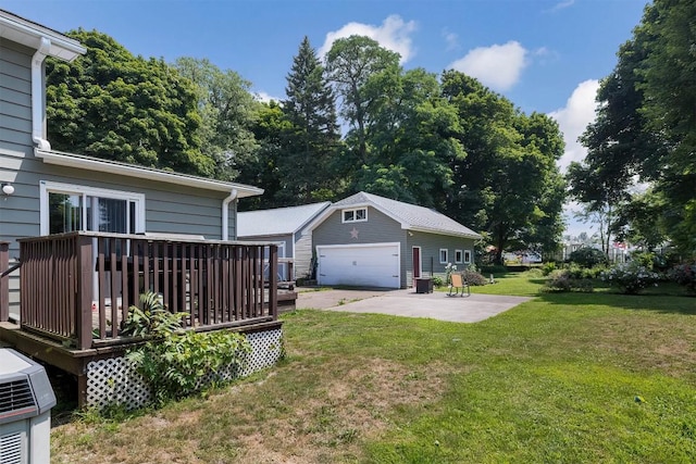 9 E Division St, North East, PA 16428 - view of grassy yard featuring an outbuilding, a deck, a garage, and a patio area