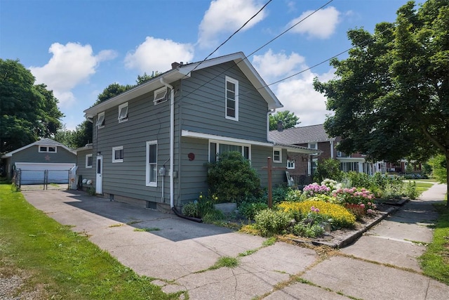 9 E Division St, North East, PA 16428 - view of side of property with an outbuilding, a detached garage, and a chimney