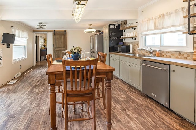 9 E Division St, North East, PA 16428 - dining space featuring a barn door, dark wood-style floors, and crown molding