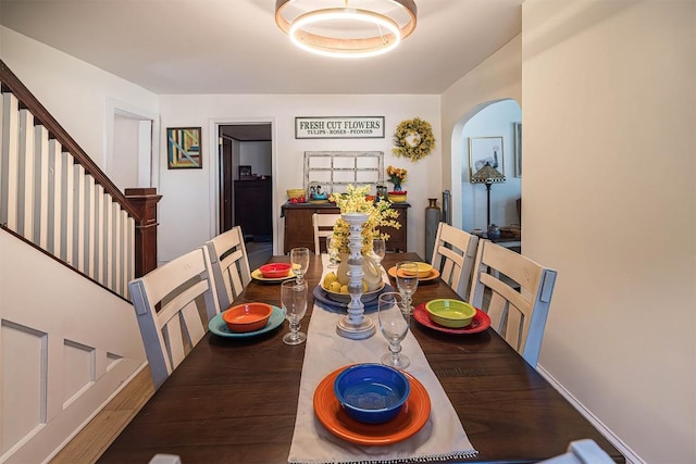 9 E Division St, North East, PA 16428 - dining space with arched walkways, stairs, and wood finished floors