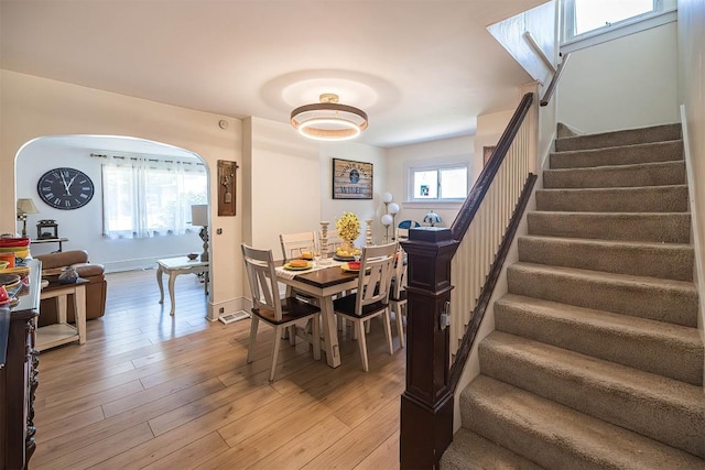 9 E Division St, North East, PA 16428 - dining room with stairway, light wood-style floors, and arched walkways