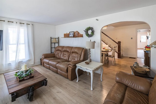 9 E Division St, North East, PA 16428 - living area featuring arched walkways, stairway, and light wood-type flooring