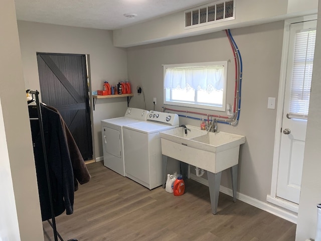 6028 Davidson Rd, Jamestown, PA 16134 - washroom with separate washer and dryer, light wood-type flooring, and baseboards