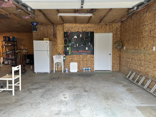 6028 Davidson Rd, Jamestown, PA 16134 - garage with freestanding refrigerator, a workshop area, and a sink