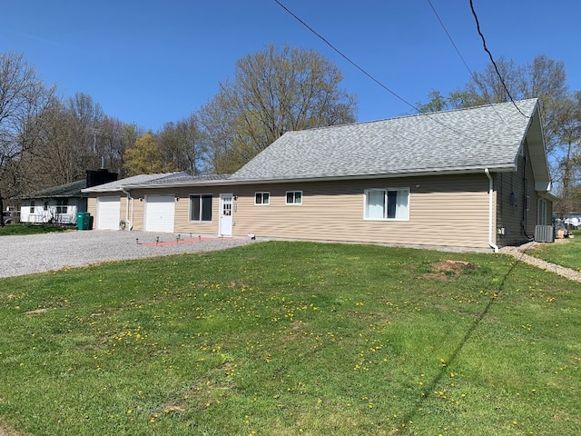 6028 Davidson Rd, Jamestown, PA 16134 - view of front of home featuring a garage, a front lawn, central AC unit, a shingled roof, and driveway