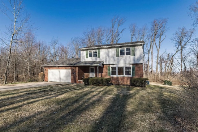 view of front of property with brick siding, driveway, a front yard, and a garage