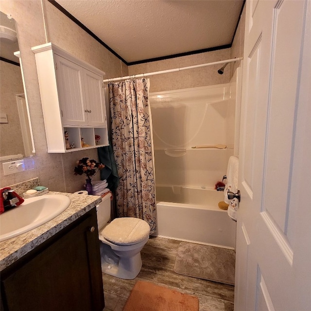 full bathroom featuring vanity, shower / bath combo, a textured ceiling, and toilet