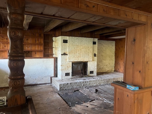 misc room featuring wood walls and a fireplace