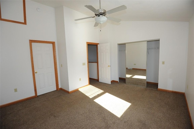 unfurnished bedroom featuring ceiling fan, high vaulted ceiling, dark carpet, and a closet