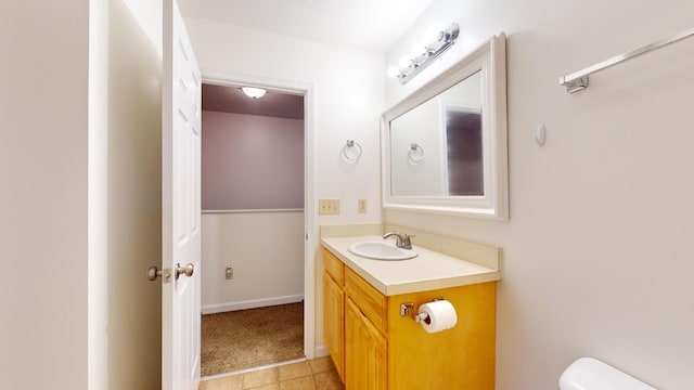 bathroom with vanity, tile patterned floors, and toilet