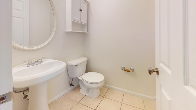 bathroom with tile patterned floors, toilet, and sink