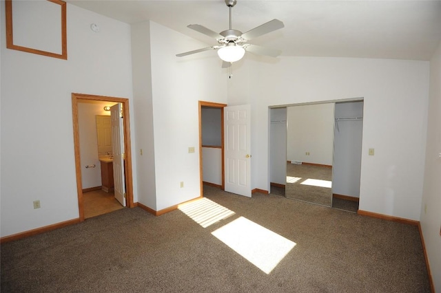 unfurnished bedroom with high vaulted ceiling, dark carpet, and ceiling fan