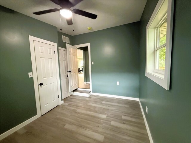 12013 Teifer Ave, Conneaut Lake, PA 16316 - unfurnished bedroom with baseboards, wood finished floors, and ceiling fan