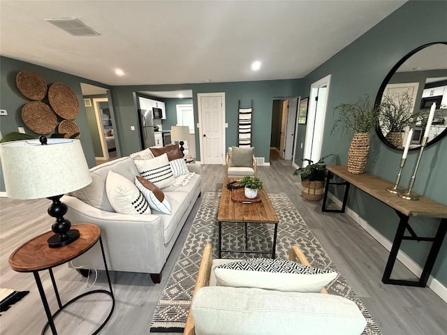 12013 Teifer Ave, Conneaut Lake, PA 16316 - living area featuring baseboards, wood finished floors, and recessed lighting