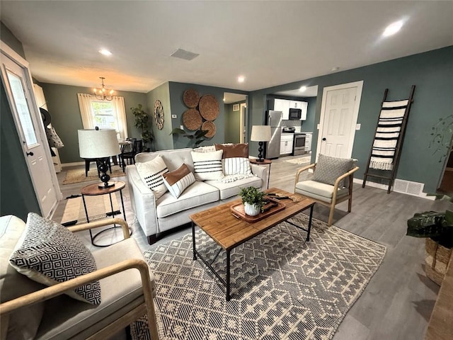 12013 Teifer Ave, Conneaut Lake, PA 16316 - living room featuring baseboards, a chandelier, wood finished floors, and recessed lighting