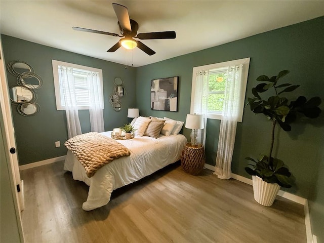 12013 Teifer Ave, Conneaut Lake, PA 16316 - bedroom featuring multiple windows, wood finished floors, baseboards, and ceiling fan