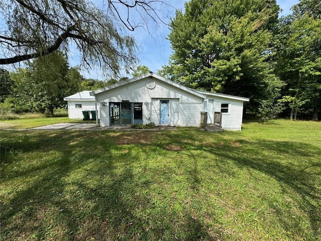 rear view of house with a yard