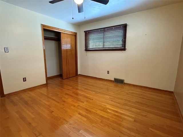 unfurnished bedroom with ceiling fan, a closet, and light hardwood / wood-style flooring