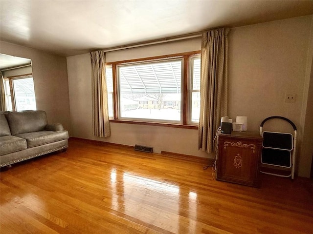 unfurnished room featuring hardwood / wood-style floors and a healthy amount of sunlight