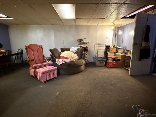 basement with carpet flooring and a paneled ceiling