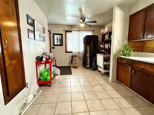 interior space featuring ceiling fan and light tile patterned floors