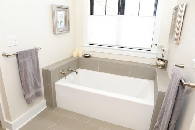 full bath featuring plenty of natural light, tile patterned floors, and a bath