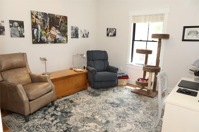 living area with wood finished floors and baseboards
