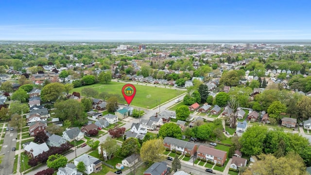 aerial view of property and surrounding area featuring nearby suburban area