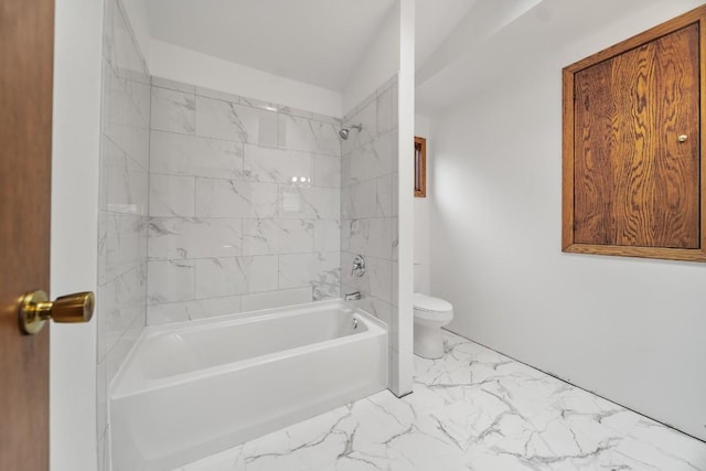 full bath with marble look tile flooring, toilet, and washtub / shower combination