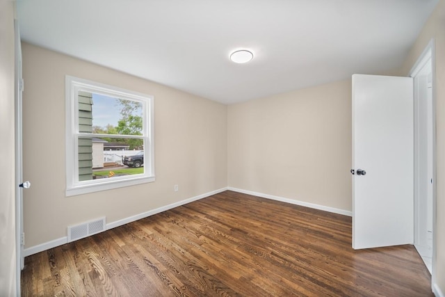 empty room with wood finished floors and baseboards