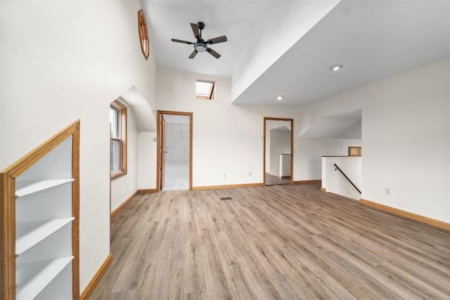 additional living space with wood finished floors, ceiling fan, baseboards, and recessed lighting