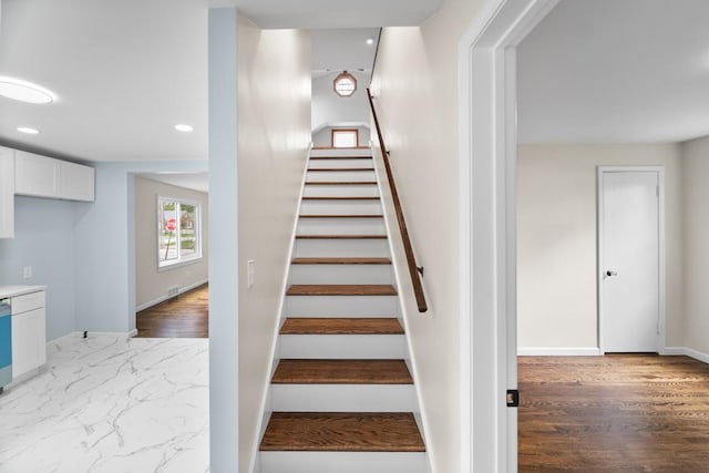 stairway featuring recessed lighting, baseboards, and wood finished floors