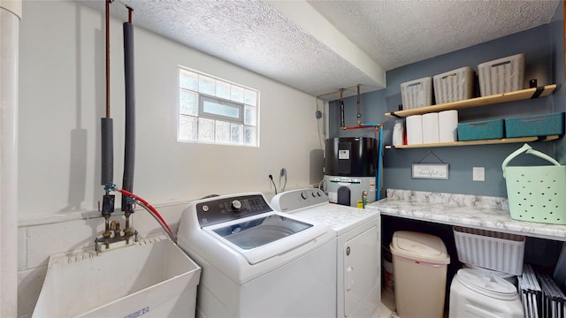 969 Lewis Way, Girard, PA 16417 - laundry area with hybrid water heater, washing machine and clothes dryer, and a textured ceiling