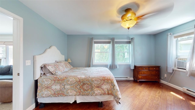 969 Lewis Way, Girard, PA 16417 - bedroom with wood finished floors, cooling unit, a baseboard radiator, and ceiling fan