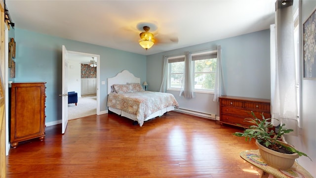 969 Lewis Way, Girard, PA 16417 - bedroom featuring baseboard heating, wood finished floors, and ceiling fan