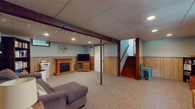 969 Lewis Way, Girard, PA 16417 - living area with a wainscoted wall, wooden walls, carpet, stairway, and a glass covered fireplace