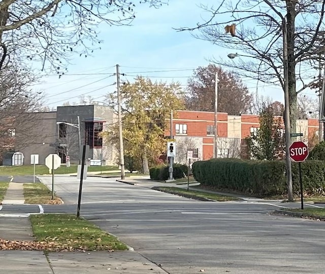 view of street with street lights, traffic signs, and sidewalks