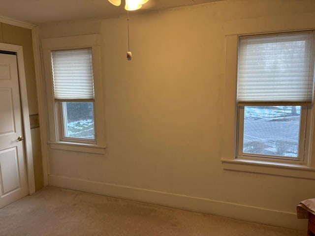 empty room with light carpet and baseboards