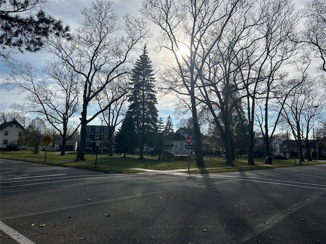 view of street with sidewalks, traffic signs, and a residential view