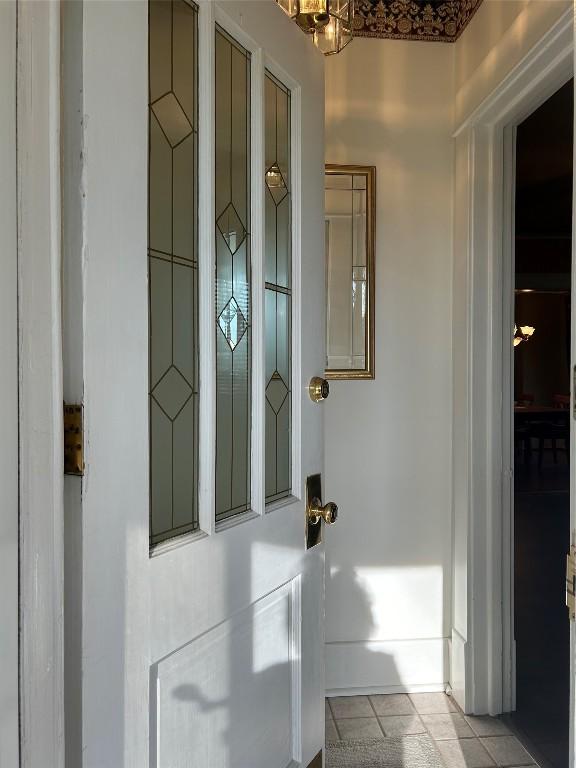 doorway to outside with light tile patterned flooring