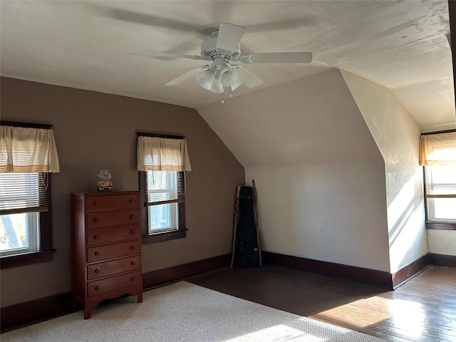 bonus room with plenty of natural light, ceiling fan, and vaulted ceiling