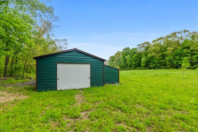 view of outbuilding with a lawn and a garage