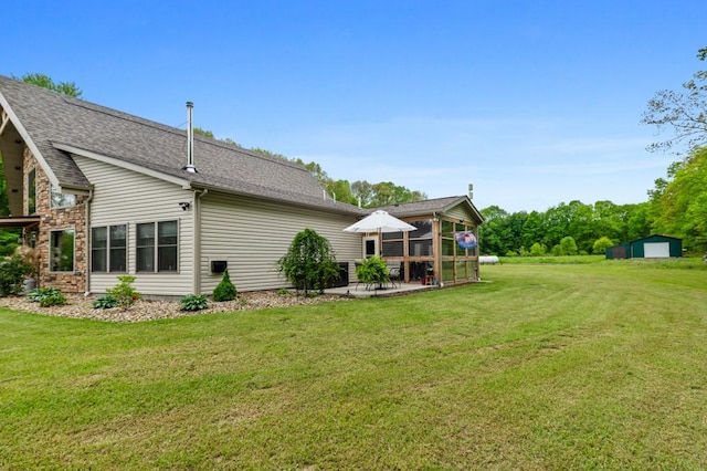 view of yard featuring a sunroom and a patio area