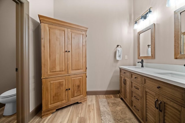 bathroom featuring hardwood / wood-style floors, vanity, and toilet