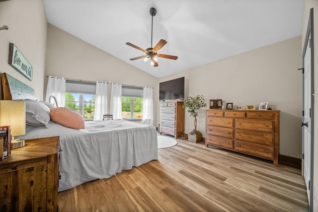 bedroom with vaulted ceiling, light hardwood / wood-style flooring, and ceiling fan