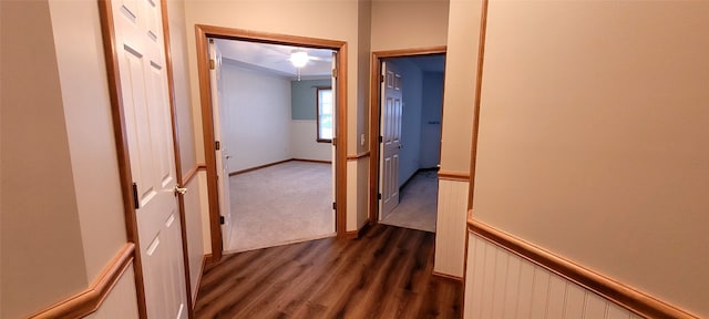 hallway with dark hardwood / wood-style flooring